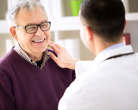 Patient and Pacoima implant dentist discussing All-On-4 dental implants