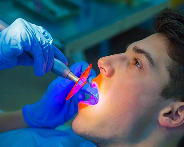 Young man undergoing dental bonding procedure