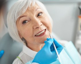 Woman receiving exam from a cosmetic dentist in Pacoima