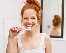 young woman brushing teeth 