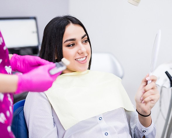 patient smiling while visiting emergency dentist in Pacoima