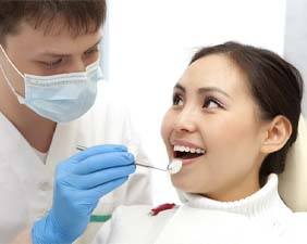 Woman receiving dental checkup from an emergency dentist in Pacoima