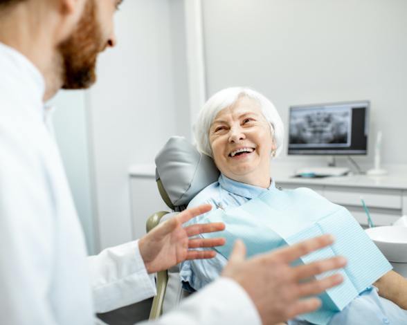 Dentist and patient discussing the cost of dental implants