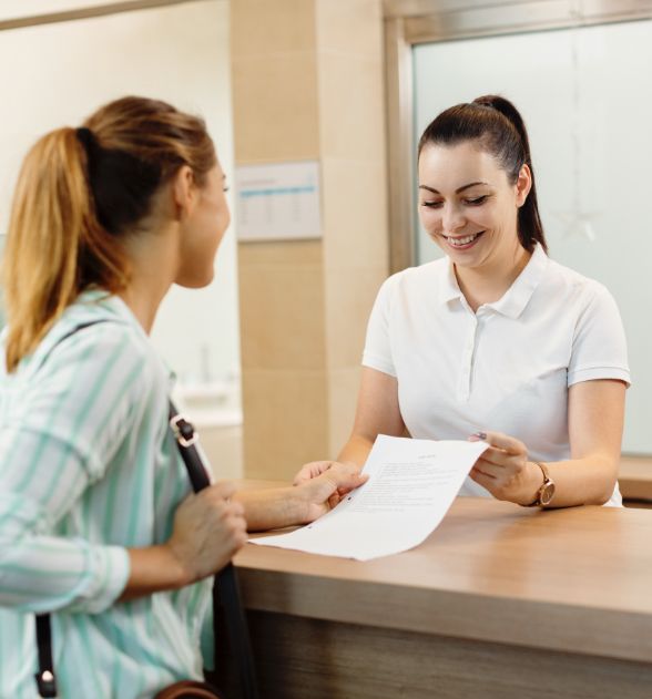 Dental concierge helping dental patient