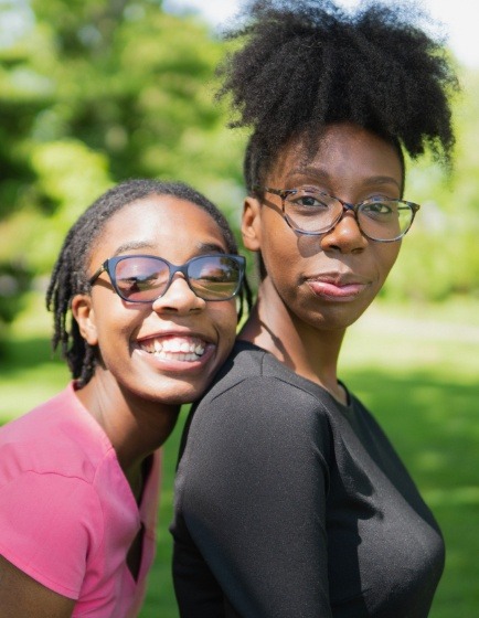 Mother and daughter smiling outdoors