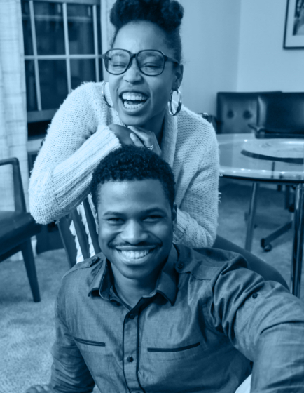 Man and woman laughing indoors