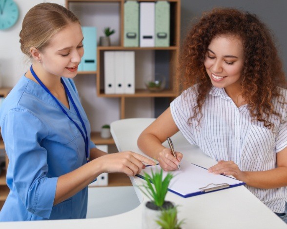 Dental team member helping patient understand how dental insurance works