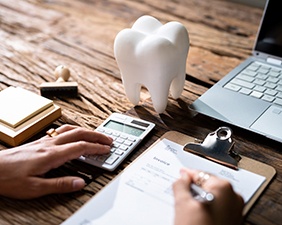 A patient calculating their dental insurance benefits