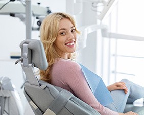 Smiling patient sitting in treatment chair