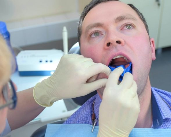 Man receiving fluoride treatment