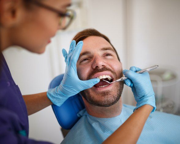 Man receiving oral cancer screening