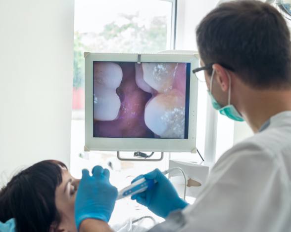 Dentist using intraoral camera to capture images