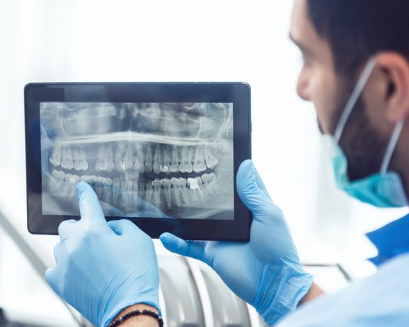 Dentist looking at Panorex digital x-rays