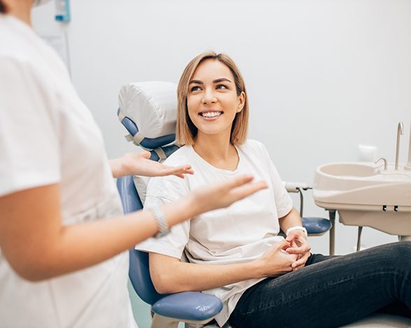 woman talking to dentist about cost of veneers in Pacoima 