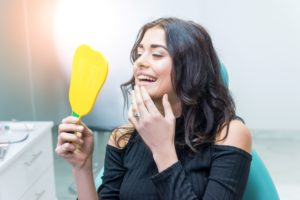 Woman at dentist looking in mirror