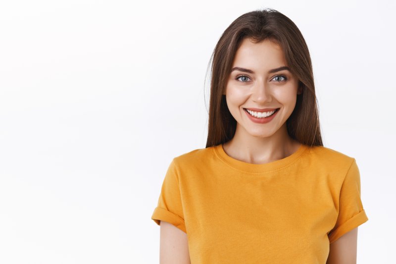 person smiling after transitioning to dental implants