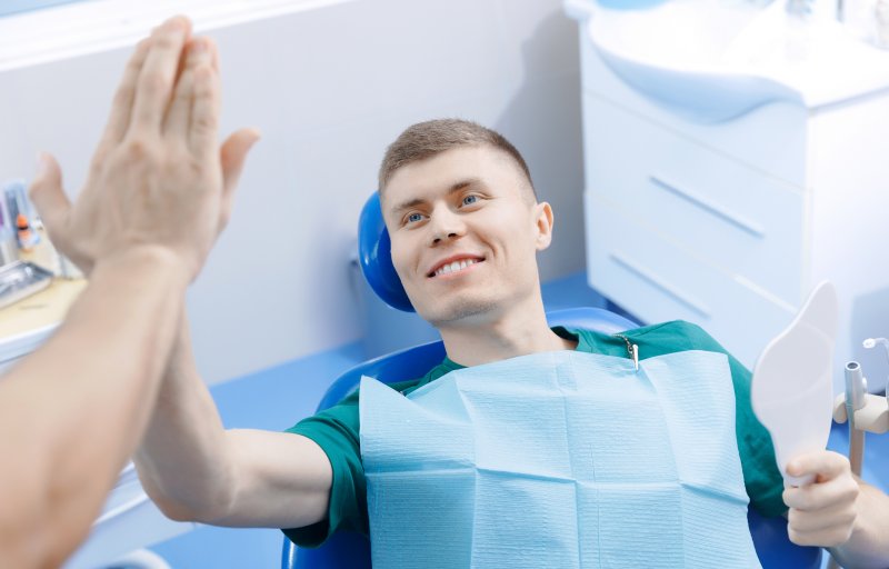 Patient high-fiving their new dentist