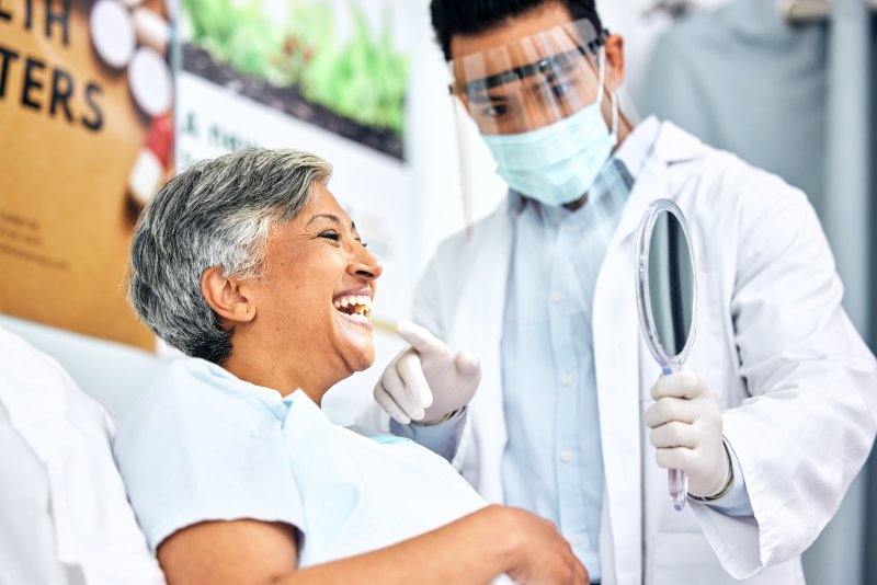 A dentist showing a woman her treatment results